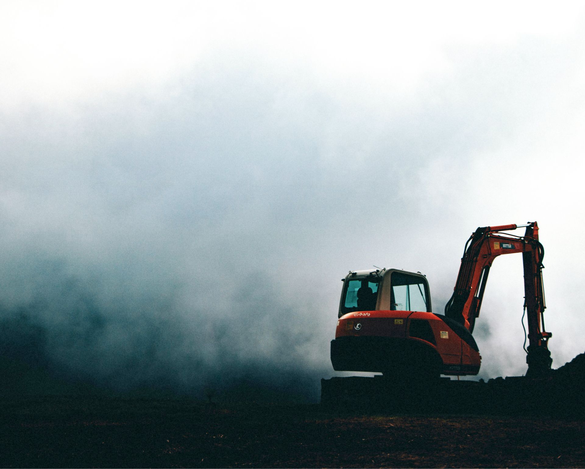 Bagger im Nebel auf einer Erhöhung